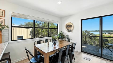 The dining room looks out to the patio and lake beyond — meals with a view, anyone?