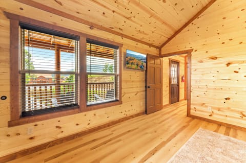 Large bunk room with queen-over-queen beds, TV, and ensuite bath.