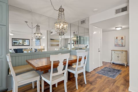 Dine in style under a chandelier in this bright open concept dining area