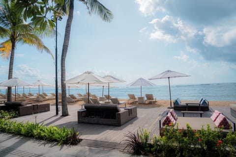 On the beach, white sand, sun loungers, beach umbrellas