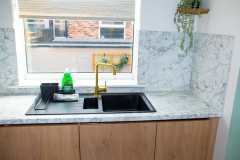 The kitchen is thoughtfully designed with both style and functionality in mind, creating a welcoming space for meal preparation