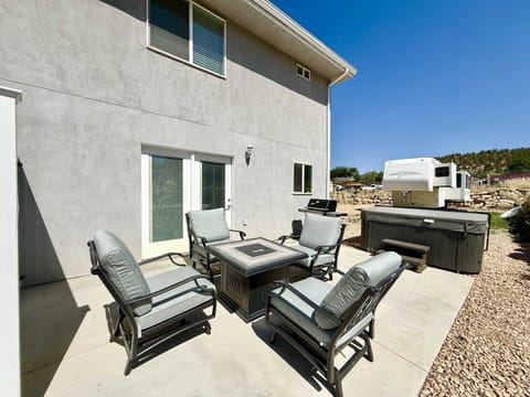The private back patio is the perfect place to gather around the fire pit, BBQ dinner, relax in the hot tub, or stargaze