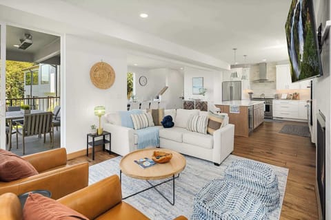 Glass doors open to the patio from this TV lounge and kitchen hub.
