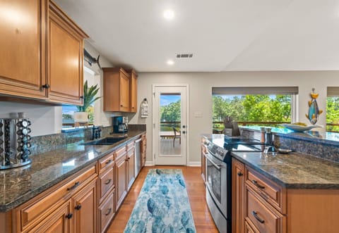 Granite counters, stainless appliances, and lake views make this kitchen a chef’s dream.