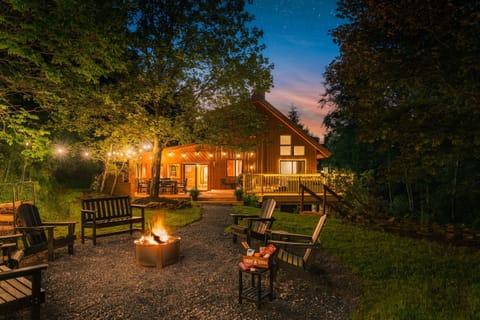 Unwind under the stars with string lights, a crackling fire, and cozy outdoor seating.