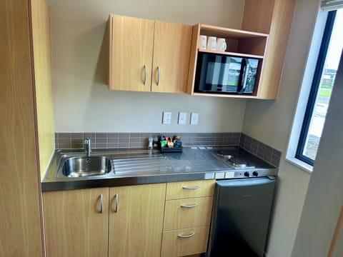 Mini-fridge, microwave, stovetop, cookware/dishes/utensils