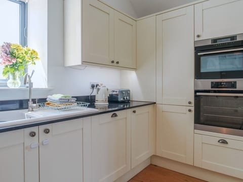 Kitchen, Kitchen Appliance, Cabinetry, Countertop, Interior Design, Wood, Flooring, Ceiling, Major Appliance, Lighting