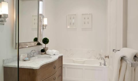 Deluxe Queen at Blue Door Inn | Bathroom | Designer toiletries, hair dryer, bathrobes, towels