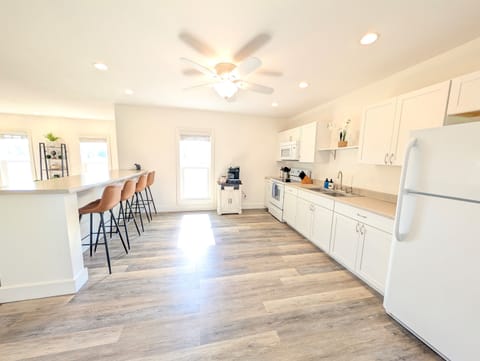 Fully stocked kitchen with coffee bar and seating for 4 at the kitchen counter in the upstairs.