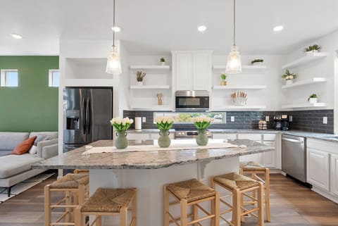 Modern kitchen with granite island and seating for six.