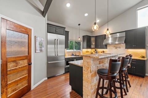 Our fully stocked kitchen features high-end appliances, a spacious layout, and a large island with bar-height seating—perfect for morning coffee, casual meals, or just hanging out with the chef.