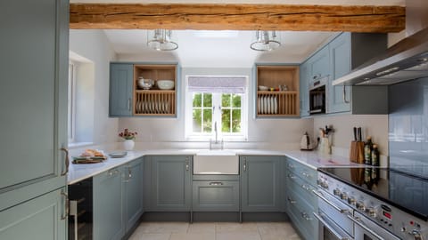 The traditional kitchen has been given a stylish twist with blue units and a fabulous range cooker