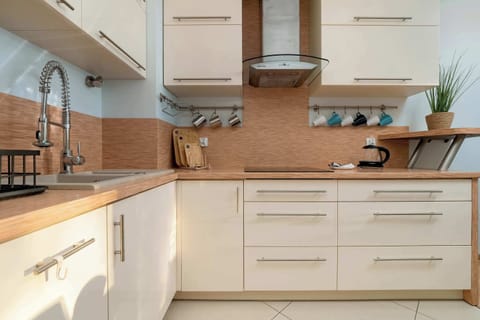 A modern kitchen with a spacious countertop and full equipment inspires you to cook your favorite meals.