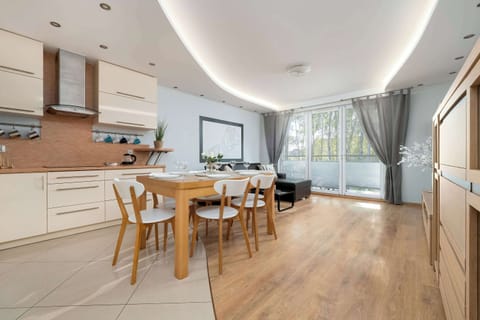 A bright dining area with a large table offers a pleasant setting for meals in natural light.

