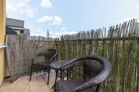 A reed-screened balcony offers a private nook for morning coffee or evening wine.

