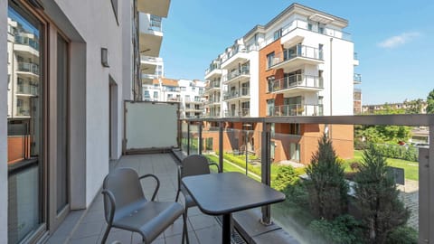 Balcony with garden furniture and a view of the estate.