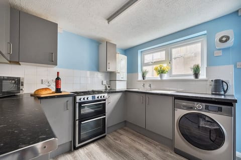 Modern kitchen with washing machine and bright windows