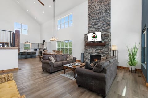 Spacious Open Living Area with A Fireplace, TV, and Natural Light