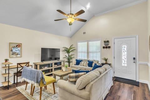 Spacious Living Room | Cozy Seating, Large TV & Open Layout to Kitchen