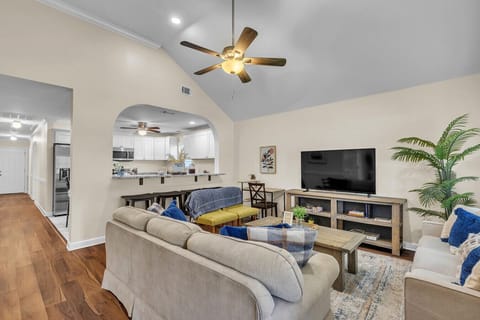 Spacious Living Room | Cozy Seating, Large TV & Open Layout to Kitchen