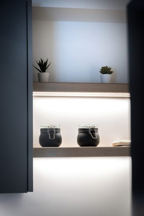 Elegant illuminated shelves with chic decor, perfect for a modern and cosy vibe.