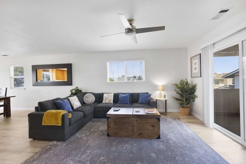 Living room with large sectional, smart TV and games