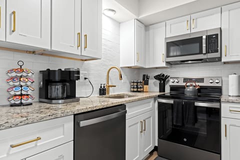 Enjoy a gourmet setup with stainless steel appliances, stylish backsplash, and convenient cooking essentials.