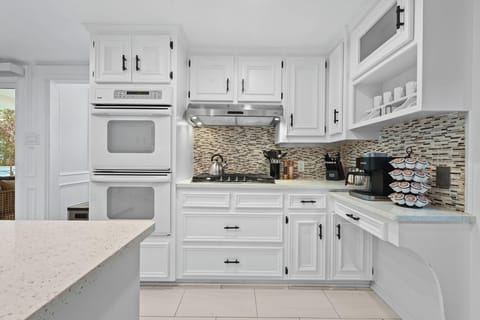 Appliances include large fridge, double stove, dishwasher, and microwave