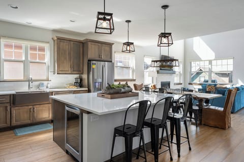 - Modern kitchen with oversized island and barstools for casual breakfasts - Pendant lights, stainless appliances, and plenty of prep space for all - Perfect for meal prepping, chatting with friends, or pouring wine at night