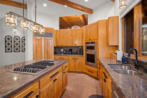 Fully-equipped kitchen with stainless appliances, Keurig, and espresso machine
