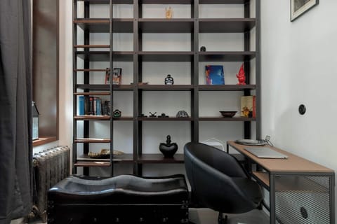 A modern office or library area with black shelving and a desk. Ideal for working or studying from home.