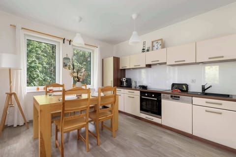 The stylish kitchen connected to the dining area creates an open and functional space for cooking and dining together.