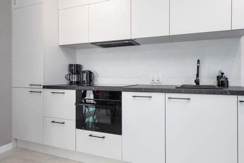 Kitchenette with plenty of kitchen utensils and dishes.