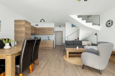 The open-plan living area seamlessly connects the kitchen, dining room, and lounge for quality time together.