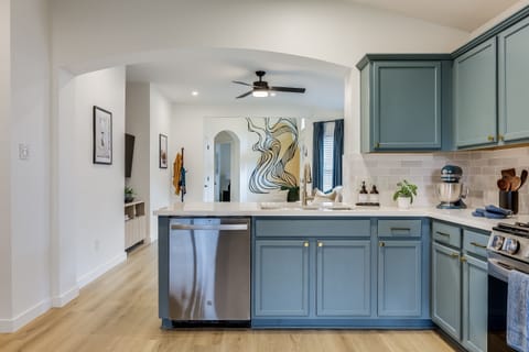 From the kitchen overlooking the living room. TV can be pulled out so you can enjoy a show while doing dishes in our deep single basin sink.