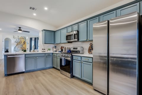 Kitchen equipped with all stainless steel appliances - freezer w/ ice maker, refrigerator w/ Brita filter, microwave, dishwasher and a gas stove