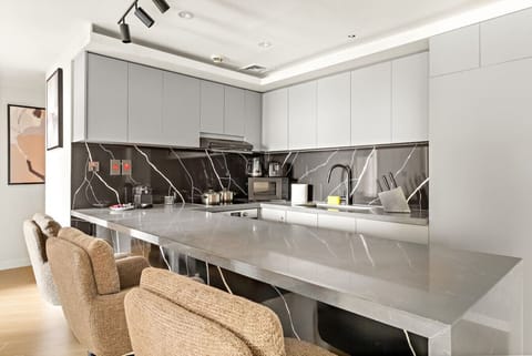 Stylish Kitchen: Whip up culinary delights in this modern space with sleek finishes and ample seating!