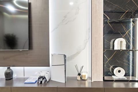 Living Room: Stylish entertainment hub with sleek decor, a gaming console, and ambient lighting!