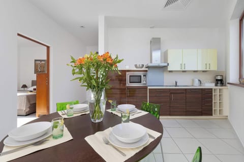 Dining table set for four, next to kitchen.

