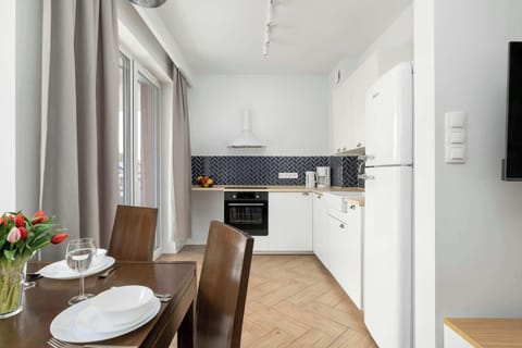 A modern open-plan living area with kitchen, dining table, and cozy lounge space. Offers comfort and practicality in one place.