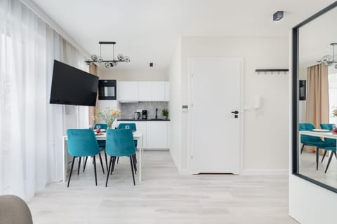 Living area with kitchenette brightened by natural light.