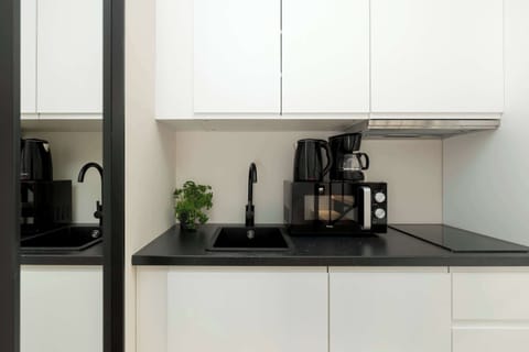 A modern kitchen with a coffee machine and induction hob makes meal prep quick and convenient.