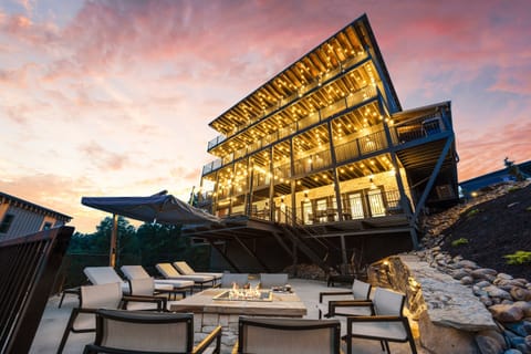 Relax on the inviting porch with warm string lights and comfortable outdoor seating. A perfect spot for morning coffee or winding down in the evening with family and friends in a peaceful and cozy setting.