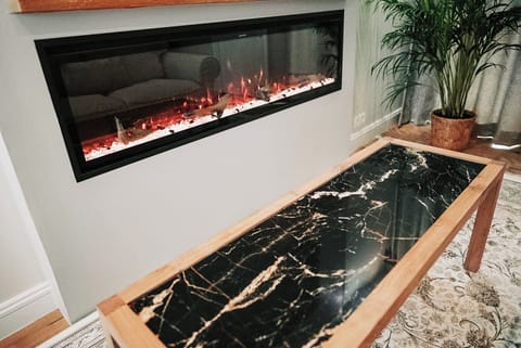 Suite, City View | Living area | 65-inch Smart TV with cable channels, fireplace