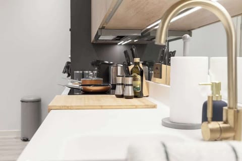 A kitchen is equipped with essential appliances and fixtures for cooking, preparing, and storing food.