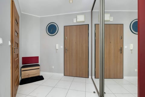 Hallway with closet and mirror.