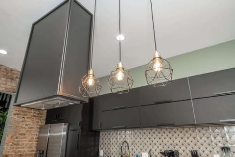 The sleek, modern kitchen offers ample space & every home comfort