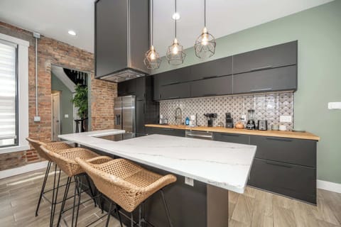 The sleek, modern kitchen offers ample space & every home comfort