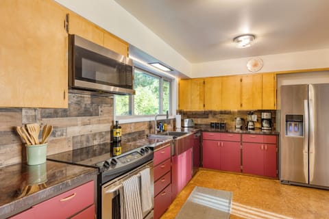 Modern kitchen with stainless steel appliances.