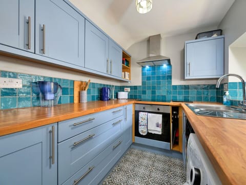 Kitchen, Countertop, Kitchen Appliance, Major Appliance, Flooring, Interior Design, Cabinetry, Wood, Floor, Kitchen Stove